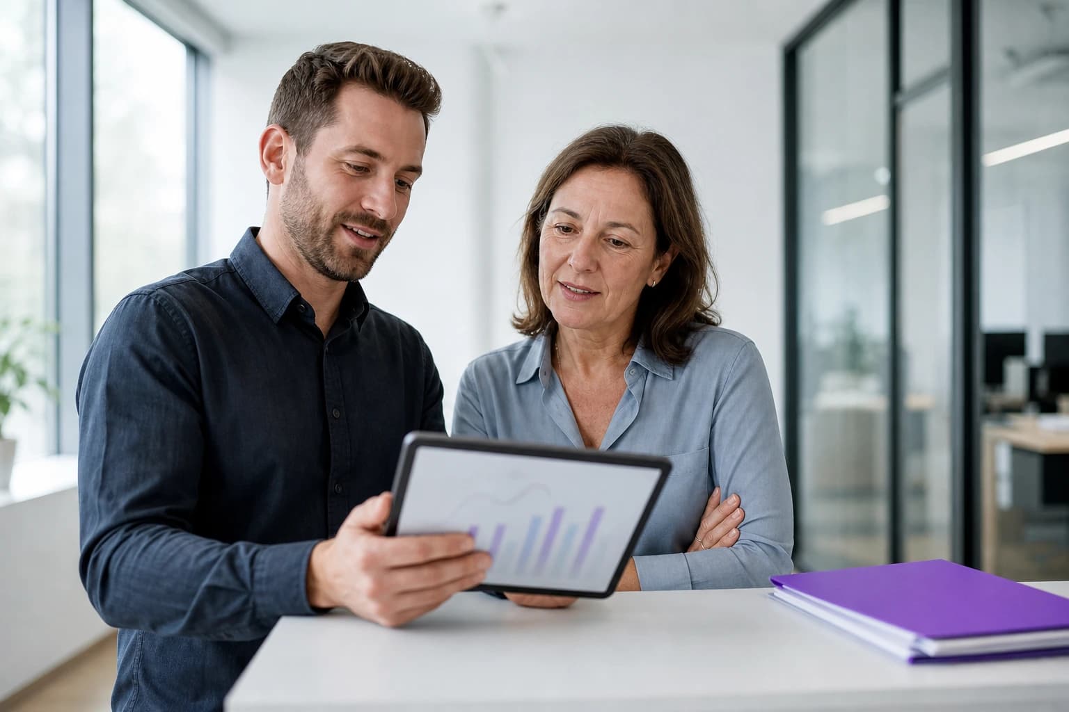Two colleagues reviewing content performance charts together on a tablet